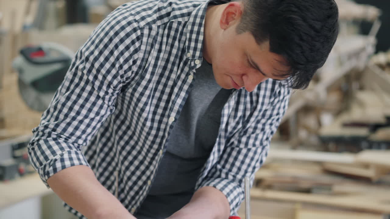 Man Working on a Wood Project in a Workshop