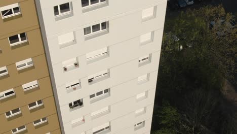 close-up aerial drone shot focusing on the facade and windows of a modern apartment building in nantes. urban architecture, housing detail. france