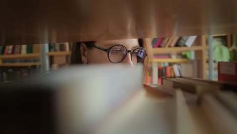 woman looking for book in library