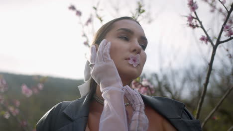 mujer con una flor en un escenario de primavera