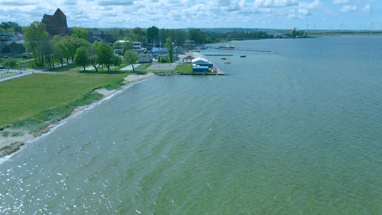 Aerial view down to top over coast, quiet sea and uninhabited beach, clear green water zatoka gdanska in Puck