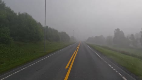 fog on a norway road. pov car trip. vehicle point-of-view driving a car on a road in norway.