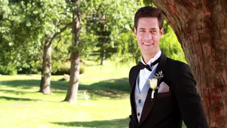 attractive groom smiling at camera