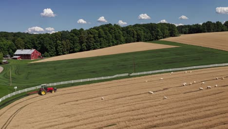 aerial view of farmland with tractor and sheep