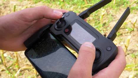 close up shot of hands operating a drone remote