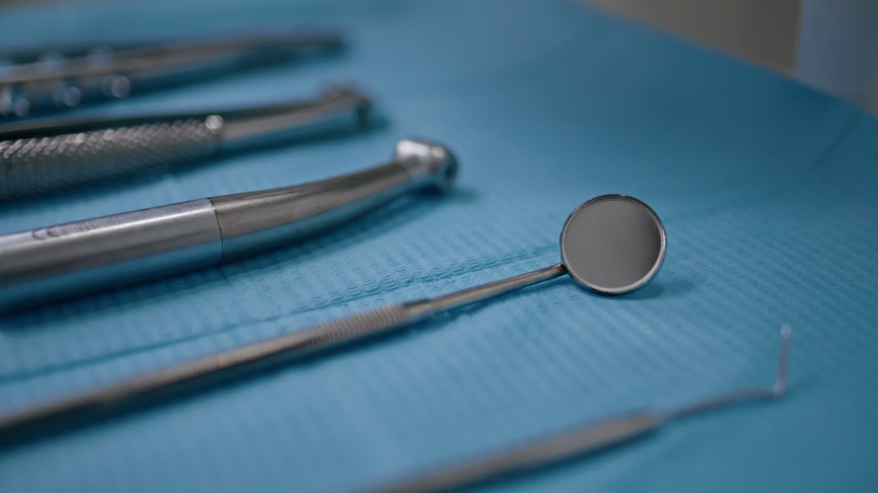 Closeup dental mirror taken by unknown dentist in stomatology. Sterilized tools