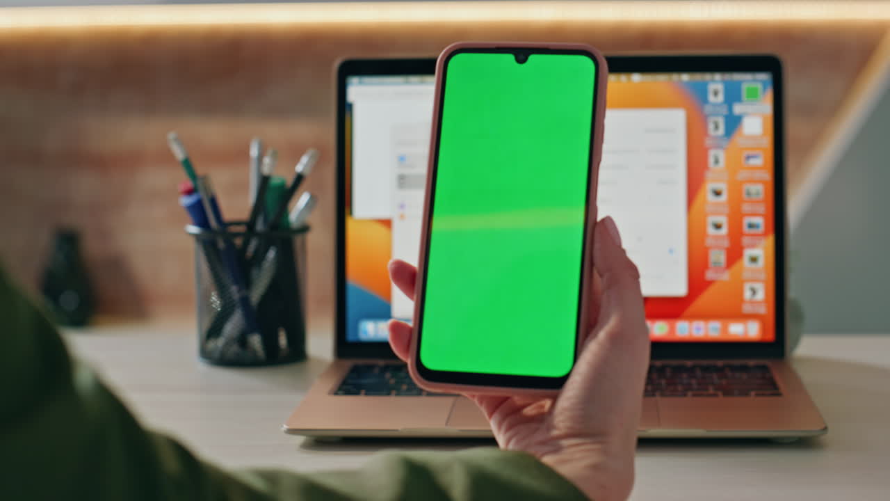 Unrecognizable businesswoman holding mockup cellphone at office desk close up.