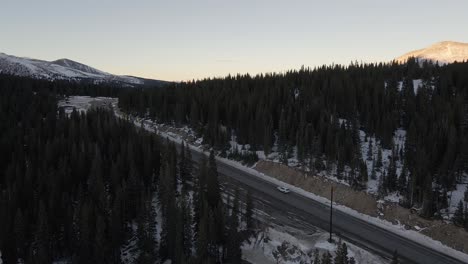 flying along highway 9 towards a mountain pass with hoosier ridge in the distance. filmed in the rocky mountains of colorado at hoosier pass between breckenridge and alma.
