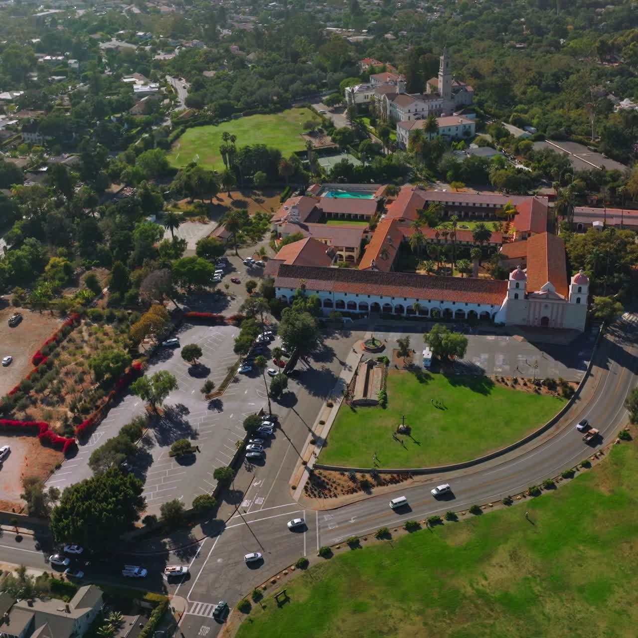 Sunny scenery of a green city with rich architecture and lots of greenery. Footage over the traffic roads of Santa Barbara, California, USA