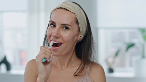 pov cheerful model brushing mouth bathroom. close up happy woman cleaning teeth