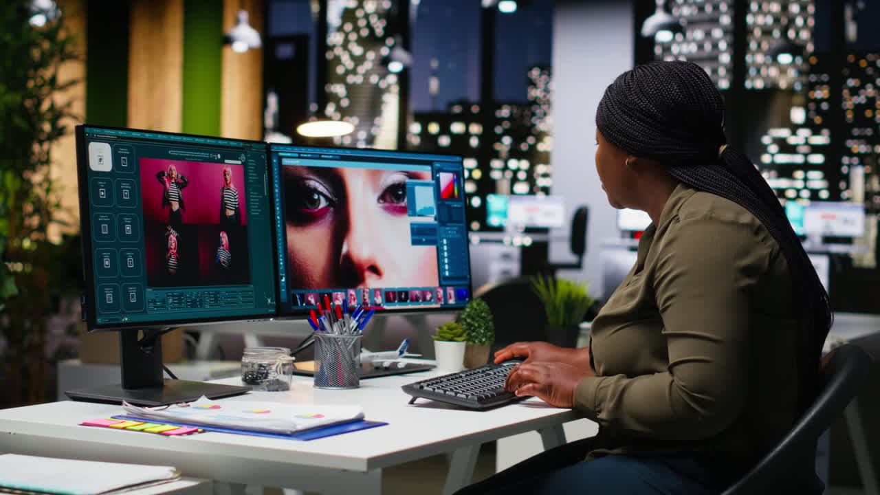 Professional woman uses editing software and AI chatbot on dual monitors