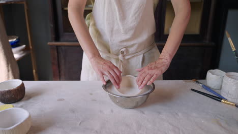 woman making pottery bowls