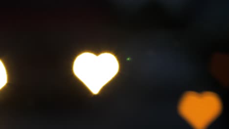 Beautiful-hearts-bokeh-from-moving-car-and-traffic-lights-at-the-evening,-Valentines-Day-or-social-media-Like-background-concept