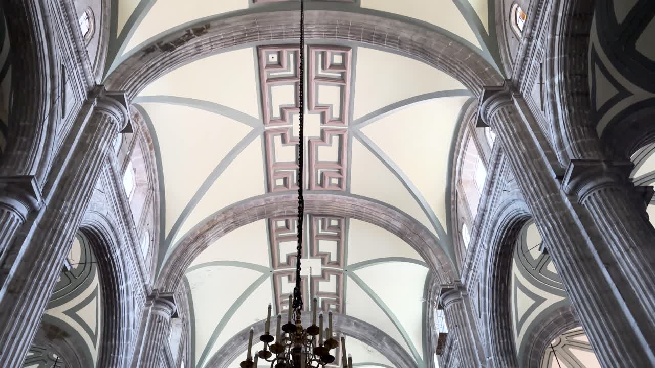 Stunning Interior of a Historic Church with Ornate Ceiling and Stone Columns