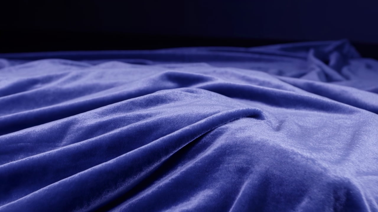 Soft Blue Velvet Sheet Rumpled On Bed, Closeup Detail Showing Plush Folds And Luminous Sheen Under Moody Low