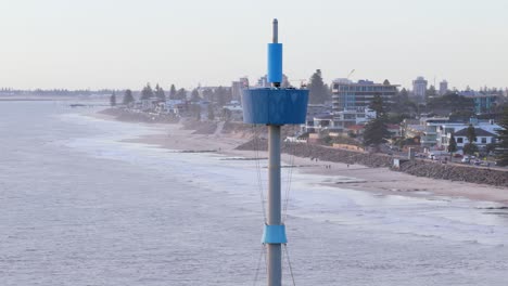 orbiting close-up drone shot of brighton beach jetty tower, adelaide, south australia