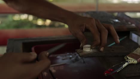 Grinding-edge-of-silver-ring-process-hand-jeweler-workshop