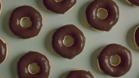 chocolate glaze donuts on a mint background