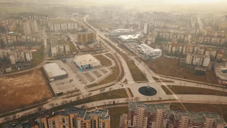 Flying-over-a-concrete-living-apartment-area-in-east-Europa-with-many-birds-flying-around-the-drone