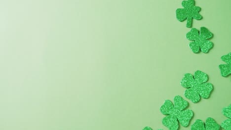 Video-of-st-patrick's-green-shamrock-leaves-with-copy-space-on-green-background