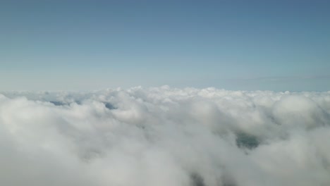 flying above beautiful thick fluffy clouds