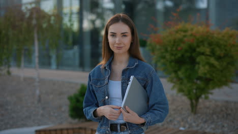 young woman with laptop outdoors