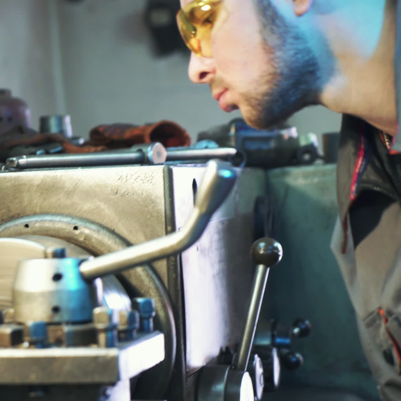 Industrial worker works at a metallurgical plant. Modern equipment for metal cutting. Square video