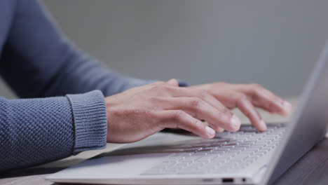 Video-of-biracial-businessman-using-laptop-on-white-background