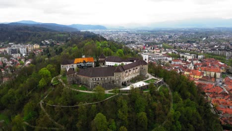 cinematic establishing drone video of ljubljana castle in cloudy weather