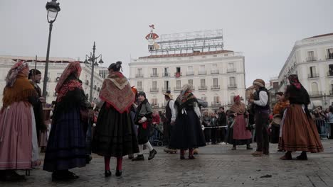 people in traditional clothes prepare on the plaza de sol in madrid, start with regional dances, static, copy space