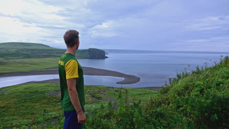 man overlooking a scenic coastal view