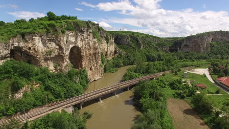 high sheer cliffs and a river crossed by a railway line located near lukovit, bulgaria