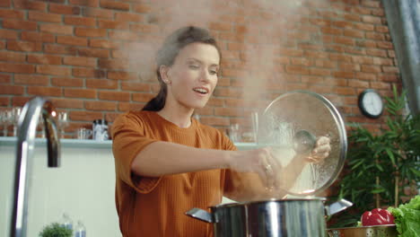 Woman-making-soup-in-kitchen.-Girl-adding-salt-to-boiling-pot.