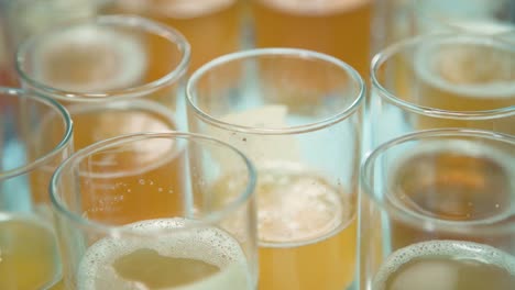 golden beer samples in glass tasters in brewery, closeup, rack focus