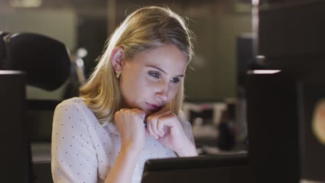 professional businesswoman working while sitting on her desk in modern office in slow motion