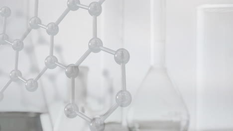 animation of chemical structures over laboratory dishes on white background