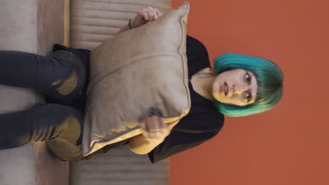 Vertical-video-of-The-young-woman-who-presses-the-pillows-on-her-head-with-fear.