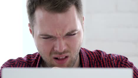 Young Man Coughing at Work