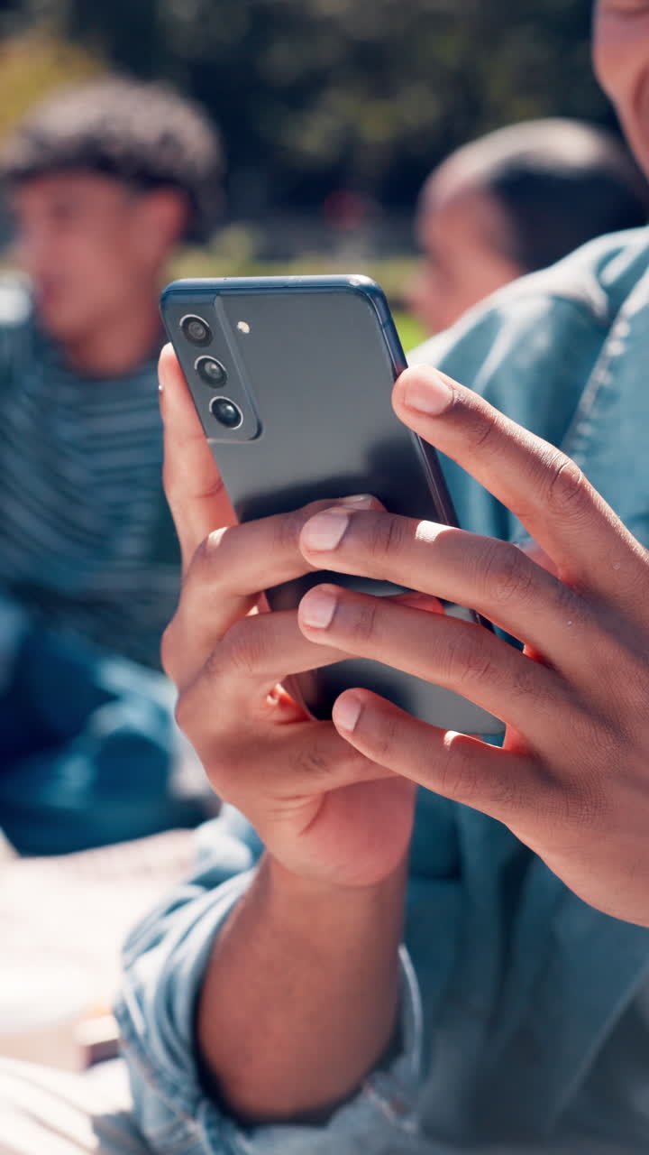 Close-Up of Person's Hands Using a Smartphone Outdoors