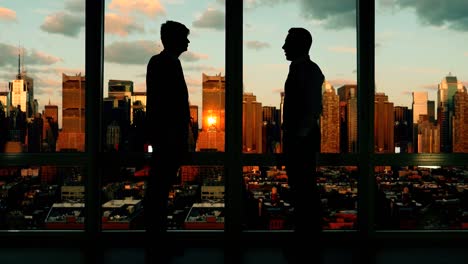 caucasian employees in businesswear working with computer. with cityscape background.