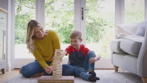 Madre-E-Hijo-En-Casa-Jugando-A-Apilar-Y-Equilibrar-Bloques-De-Madera-Juntos