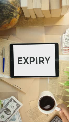 vertical video of expiry displaying on finance tablet screen