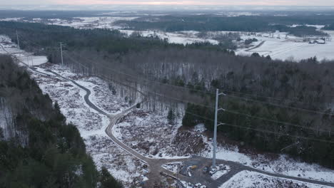 electrical power transmission lines in a winter forest, aerial panorama