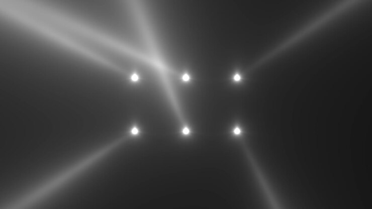 Glowing white spotlight beams on stage