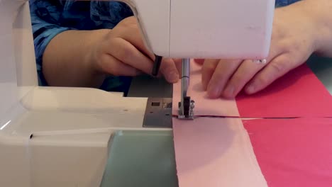 a woman chain-pieces seams on a sewing machine