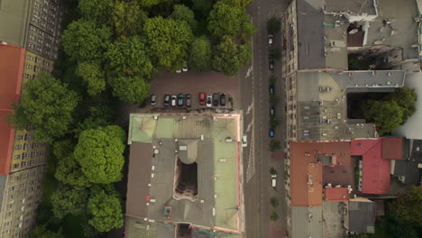 Aerial-top-down-shot-rooftop-of-complex-block-in-polish-city-at-sunrise---Cracow,Poland