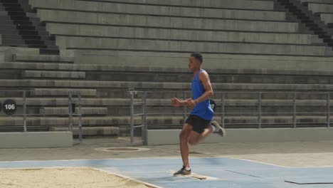 close up view of mixed race athlete doing long jump
