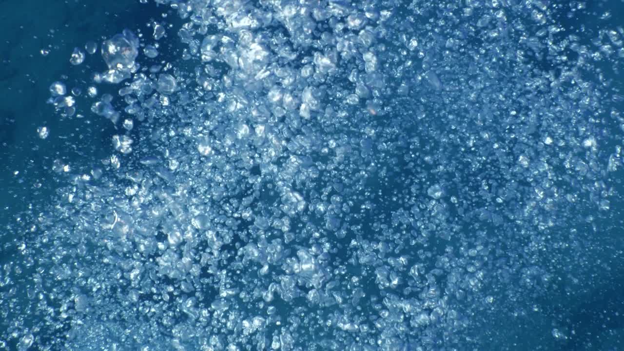 underwater close to surface with the sky view ocean scenery sun beams sun rays and air bubbles slow relaxing ocean backgrounds