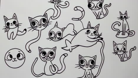 hand drawing cute cartoon cats with a marker