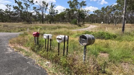 mailboxes in a rural setting, changing light and shadows